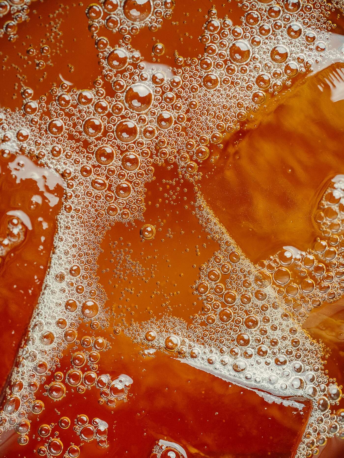 Macro of amber bubbles in an iced drink