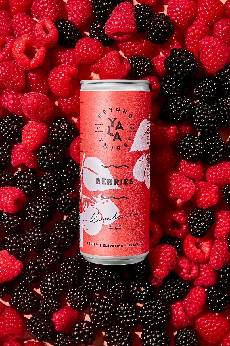 Kombucha can on a bed of fresh berries