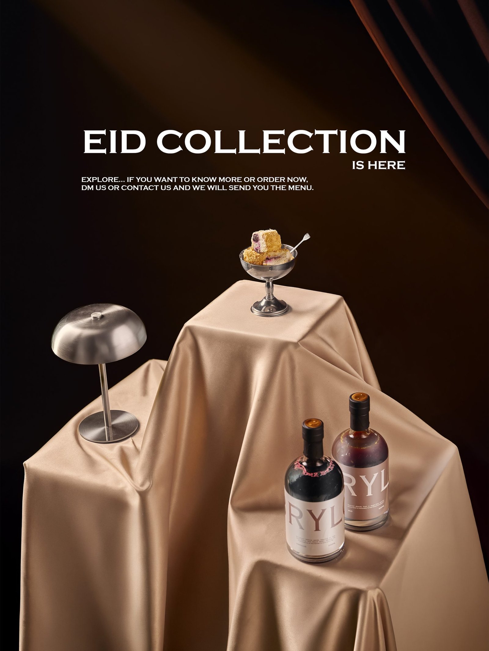 Eid collection set: a dessert coupe on a draped silk plinth beside two bottles under a lamp