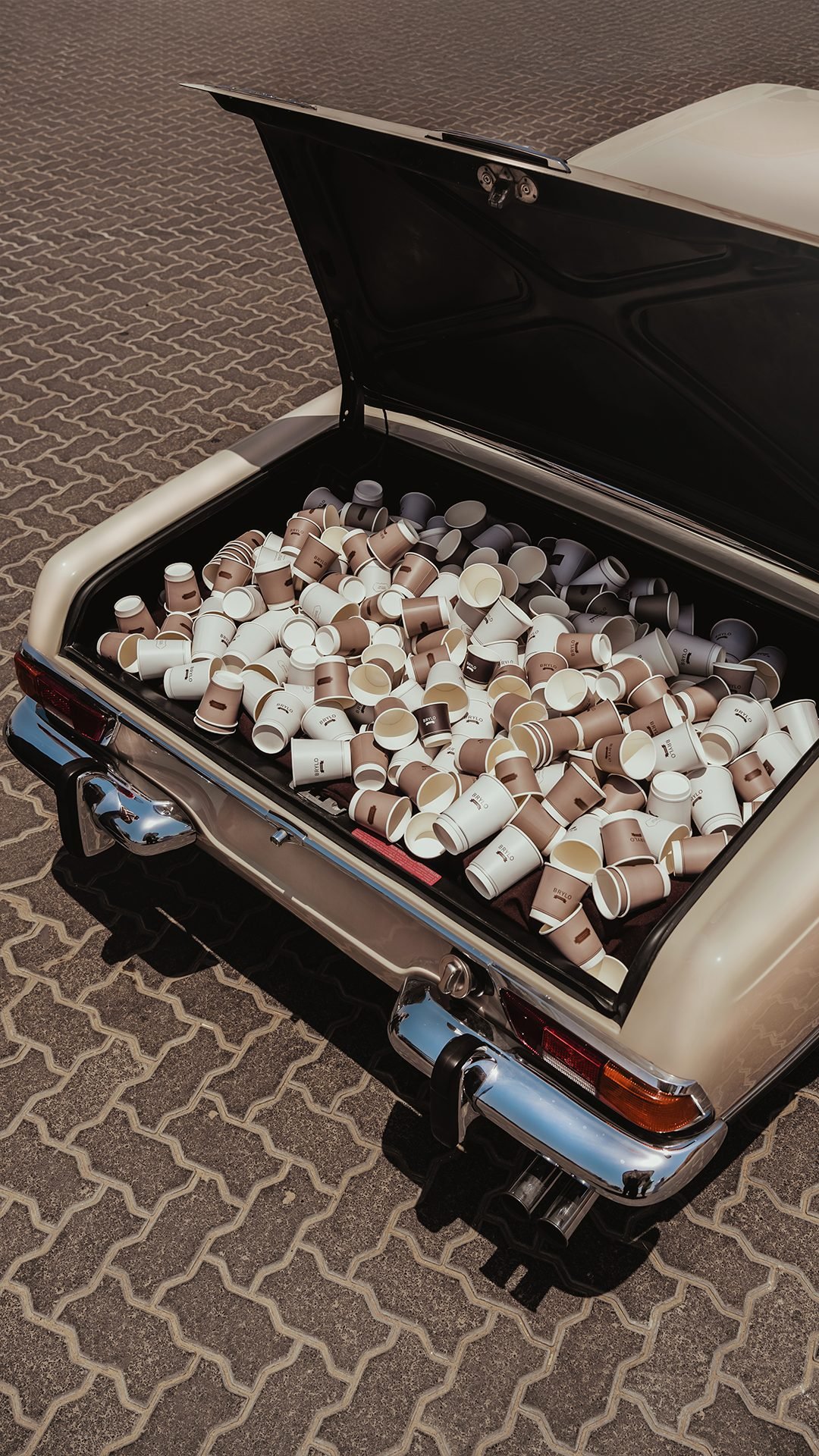 Open boot of a vintage car filled with Brylo takeaway coffee cups