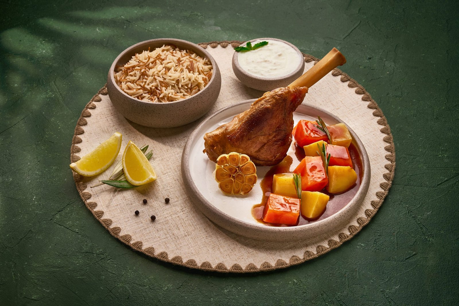Lamb shank with rice, salad and yoghurt on scalloped stoneware